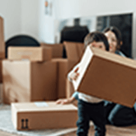 Child moving cardboard boxes